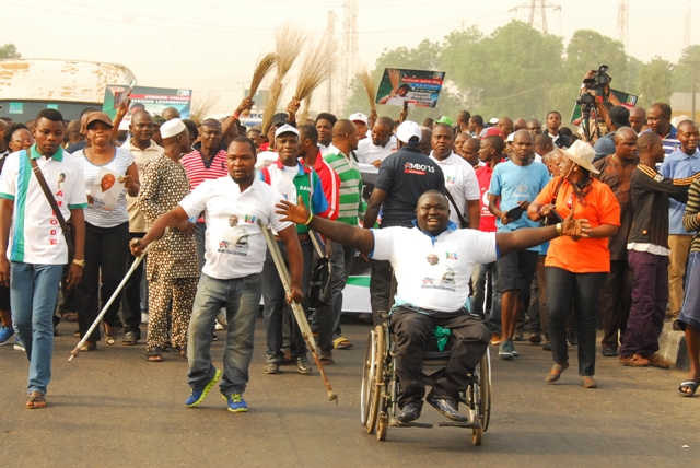 Akinwunmi Ambode and some physically challenged Lagosians during the 10,000 Man March event