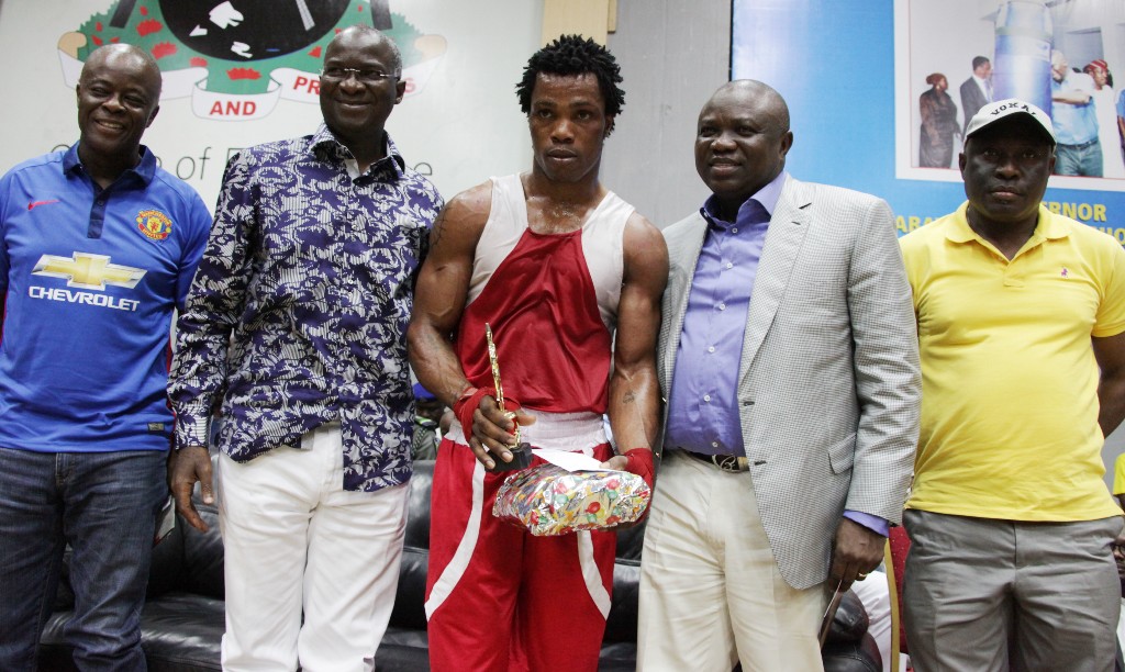 Lagos State Governor, Mr. Babatunde Fashola, SAN (2nd left), Lagos State All Progressives Congress Governorship Candidate, Mr. Akinwunmi Ambode (2nd right), Chairman, Lagos Boxing Hall of Fame, Mr. Wale Edun (left), Permanent Secretary, Youth Sports and Social Development, Mr. Oluseyi Whenu (right) and the Winner of the Male 81kg Boxing category from Lagos State, Mr. Samuel Ebohen (middle) during the 6th Annual Governor’s Belt Edition and 59th Monthly Boxing Show organized by the Lagos Boxing Hall of Fame in conjunction with the Lagos State Amateur Boxing Association under the patronage of Lagos State Government at the Sir Molade Okoya-Thomas Indoor Sports Hall, Teslim Balogun Stadium, Surulere, Lagos on Friday, December 26, 2014.